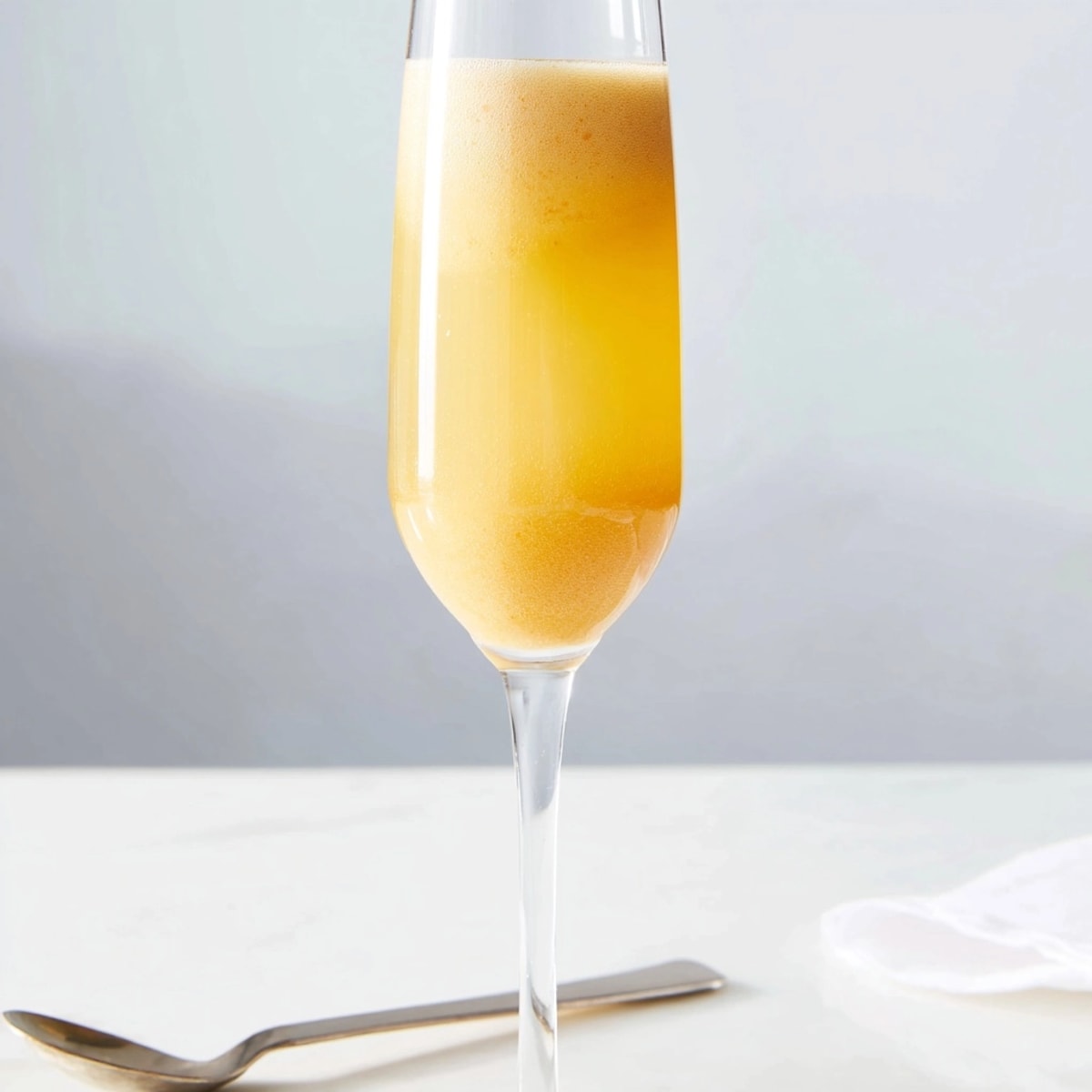 Golden peach bellini drink, summer brunch cocktail, refreshing and fruity Prosecco mix.