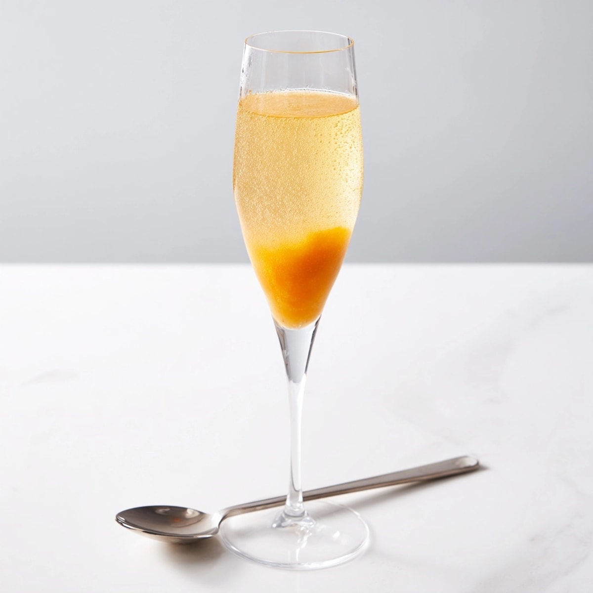 Homemade peach bellini recipe – vibrant color, bubbly prosecco, perfect celebratory drink.