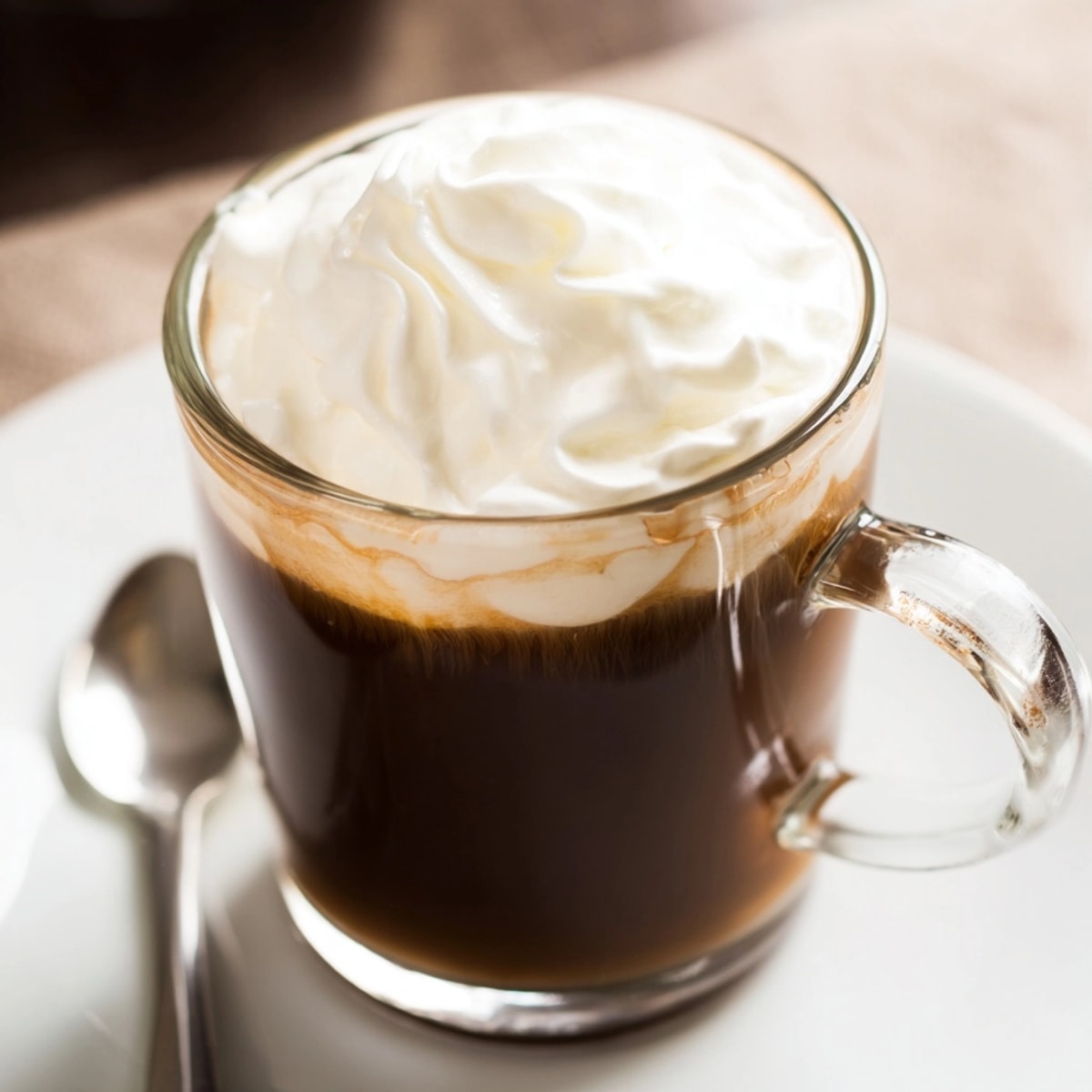 Creamy homemade Irish Coffee recipe swirled beautifully, perfect spiked coffee for chilly evenings.
