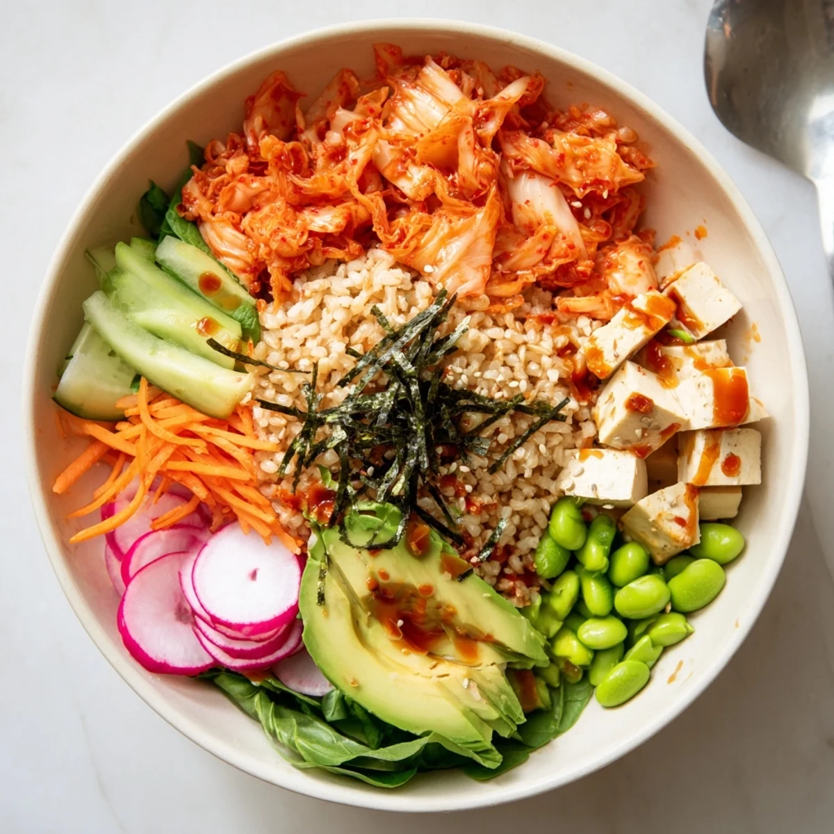 Vibrant Fermented Vegetable Bowl topped with avocado, fresh greens, and crunchy sesame seeds.  
