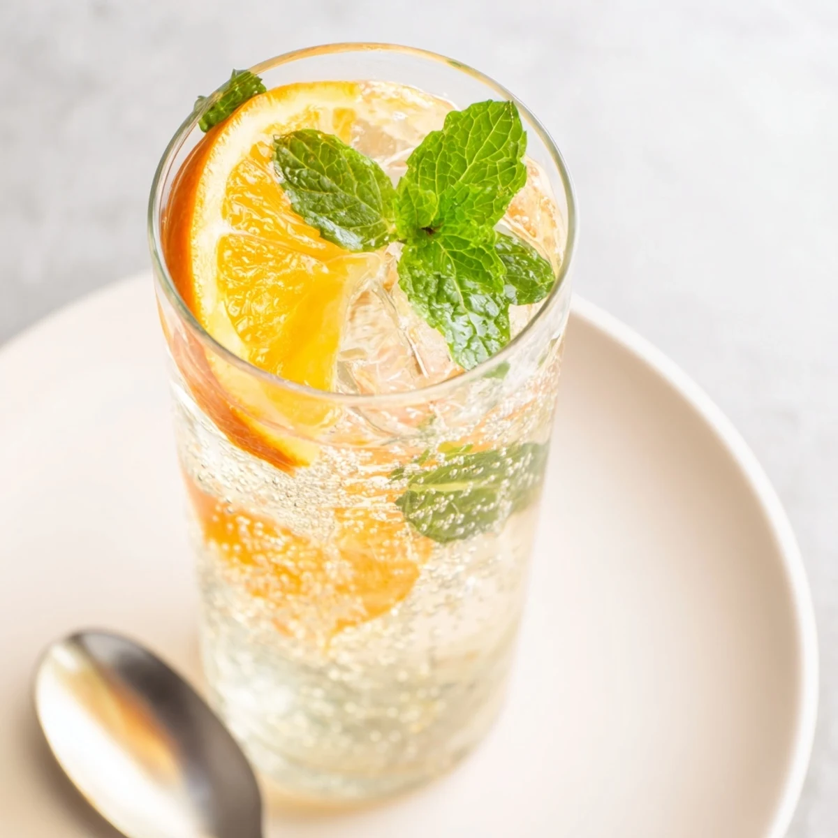 Homemade probiotic soda mocktail bursting with citrus flavors and vibrant mint aroma.
