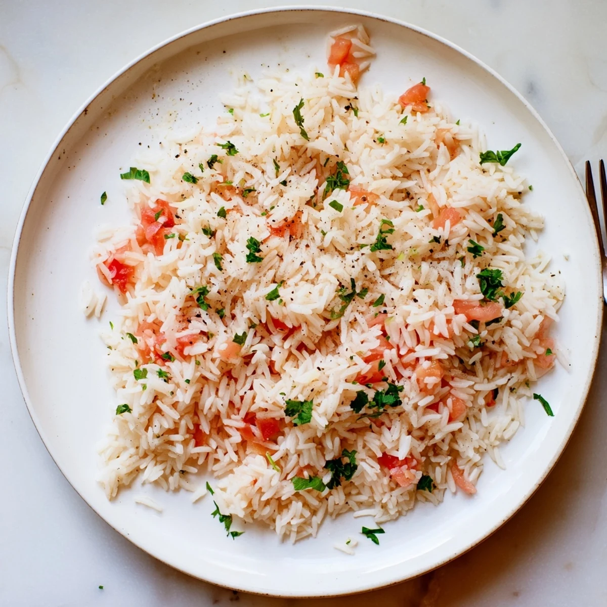 Steaming Tomato-Rice Skillet Dinner, featuring fluffy rice with bright red tomatoes, ready to serve.
