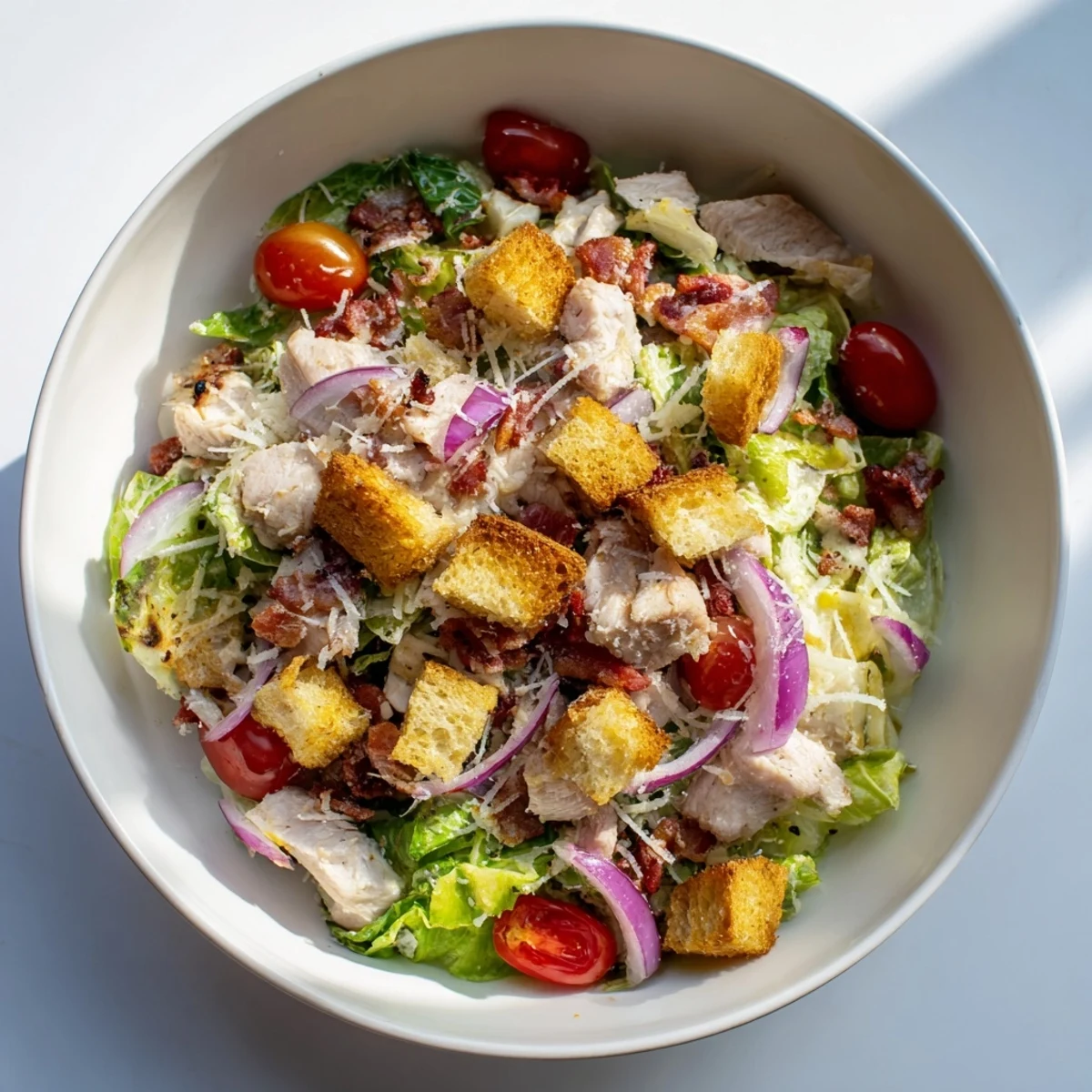 Vibrant Costco Chicken Bake Salad Bowl with roasted chicken, crispy bacon, and creamy dressing, perfect meal.