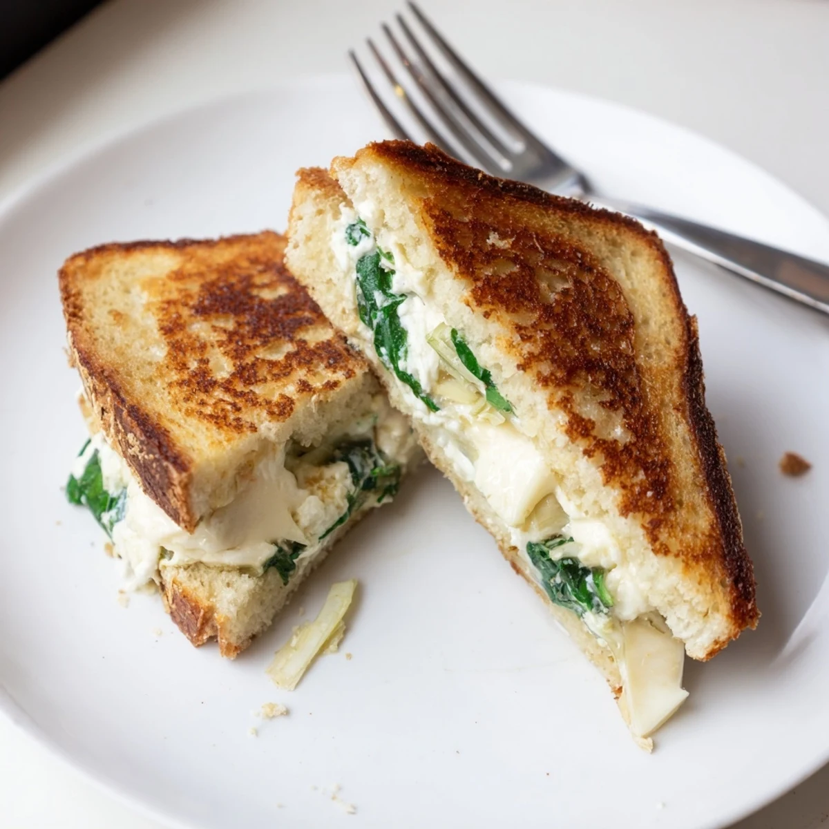 Inside the image is a close-up of Air Fryer Spinach & Artichoke Dip Grilled Cheese, with oozing melted cheese.