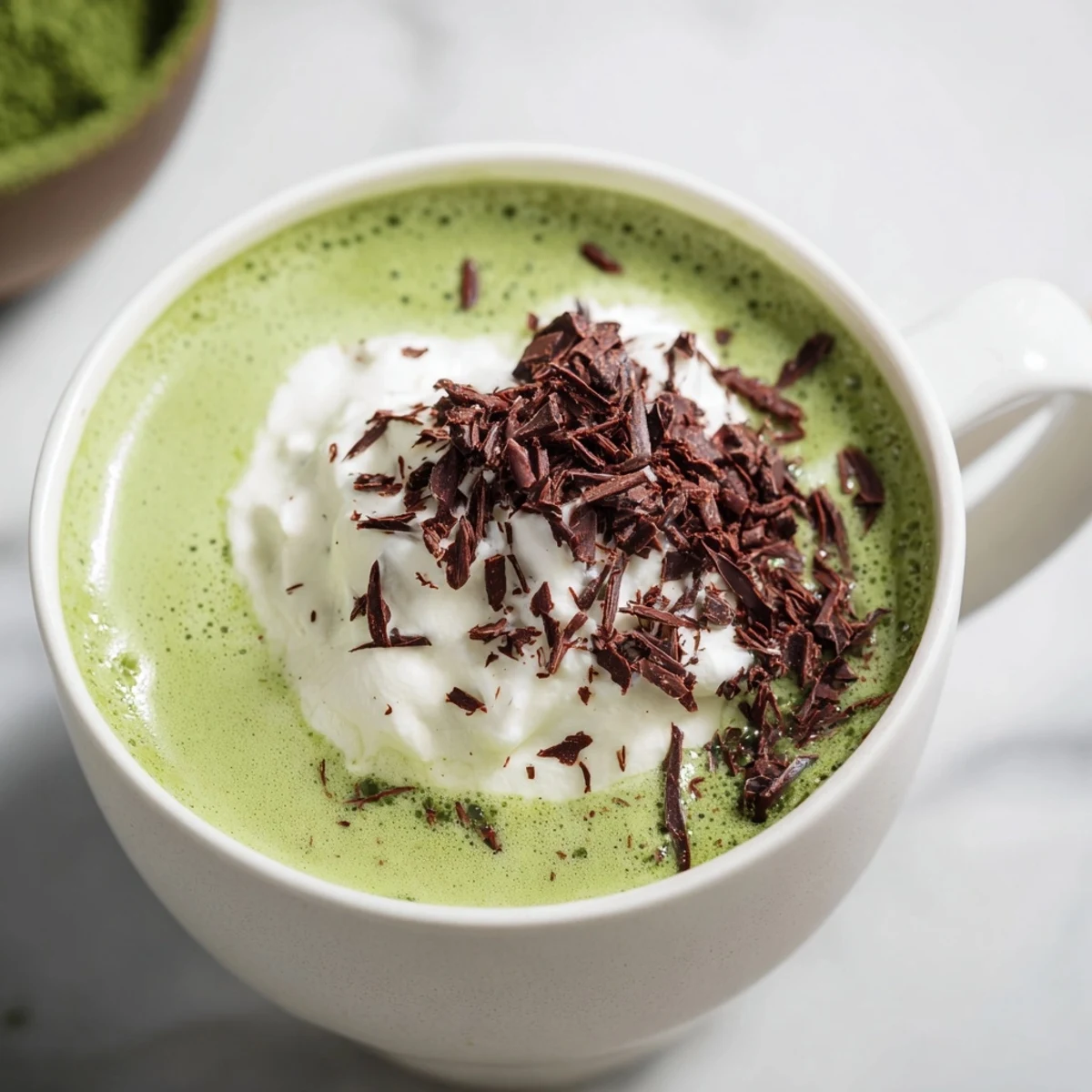 Imagine a creamy Collagen Peppermint Mocha Matcha Latte swirled with cocoa, topped with optional whipped cream.
