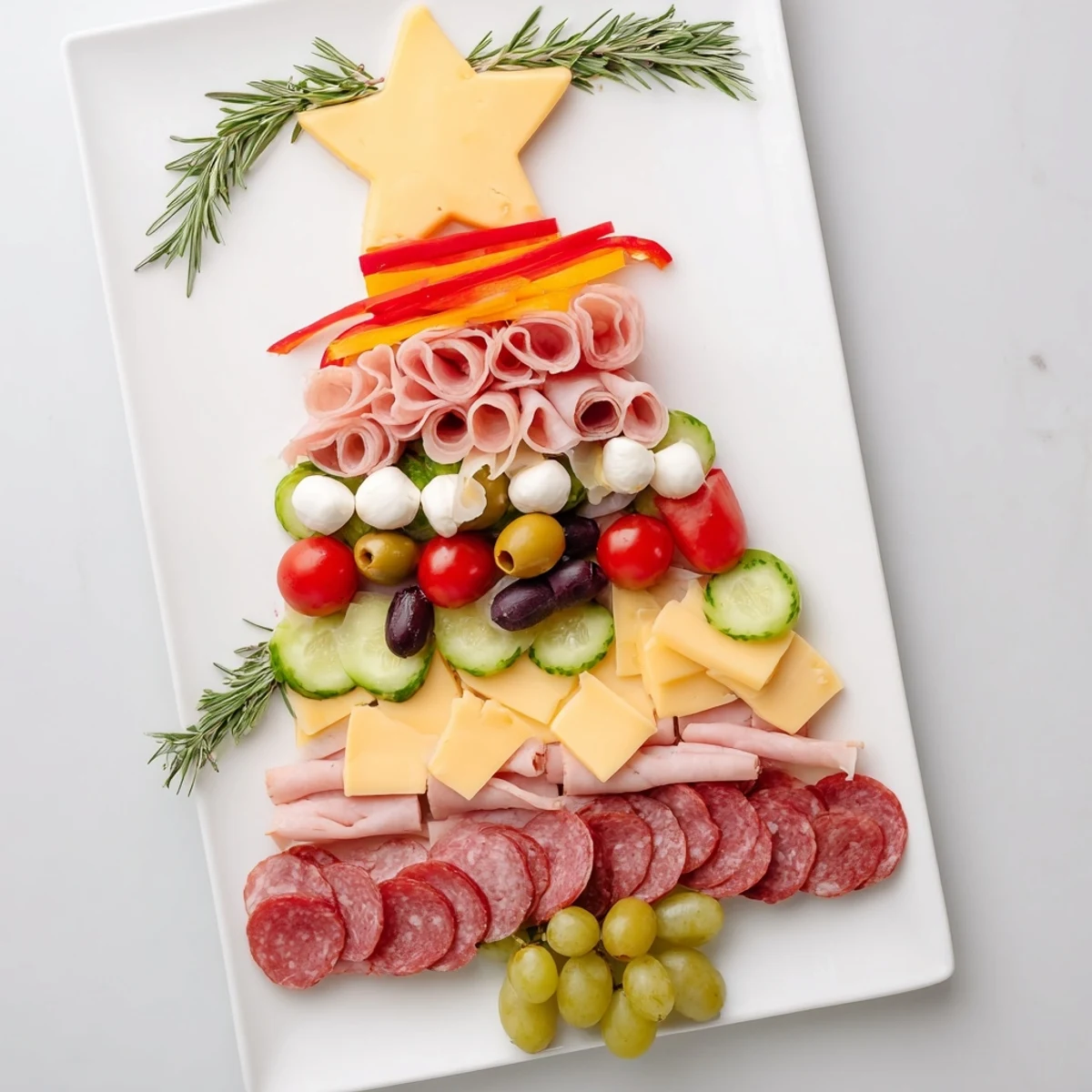 Christmas Tree Charcuterie Board: a delicious, colorful appetizer with meats, cheeses, and grapes for holiday fun.