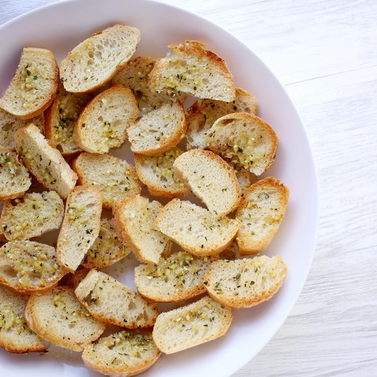 Golden-baked baguette slices presented in a circle, offering a rustic appeal for sharing and flavor.