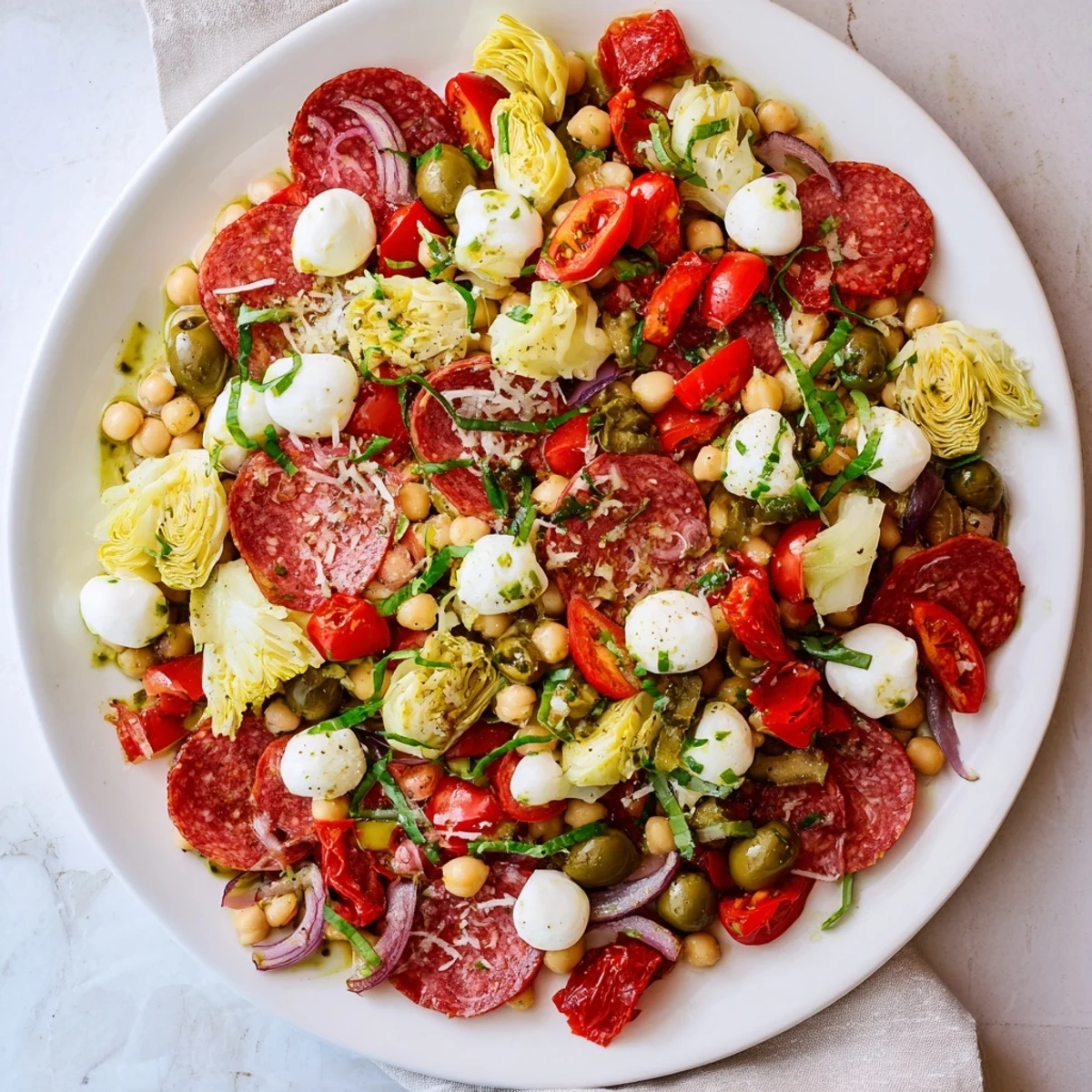 Vibrant Antipasto Chickpea Salad with pepperoni, mozzarella, and a tangy vinaigrette, perfect for a picnic.