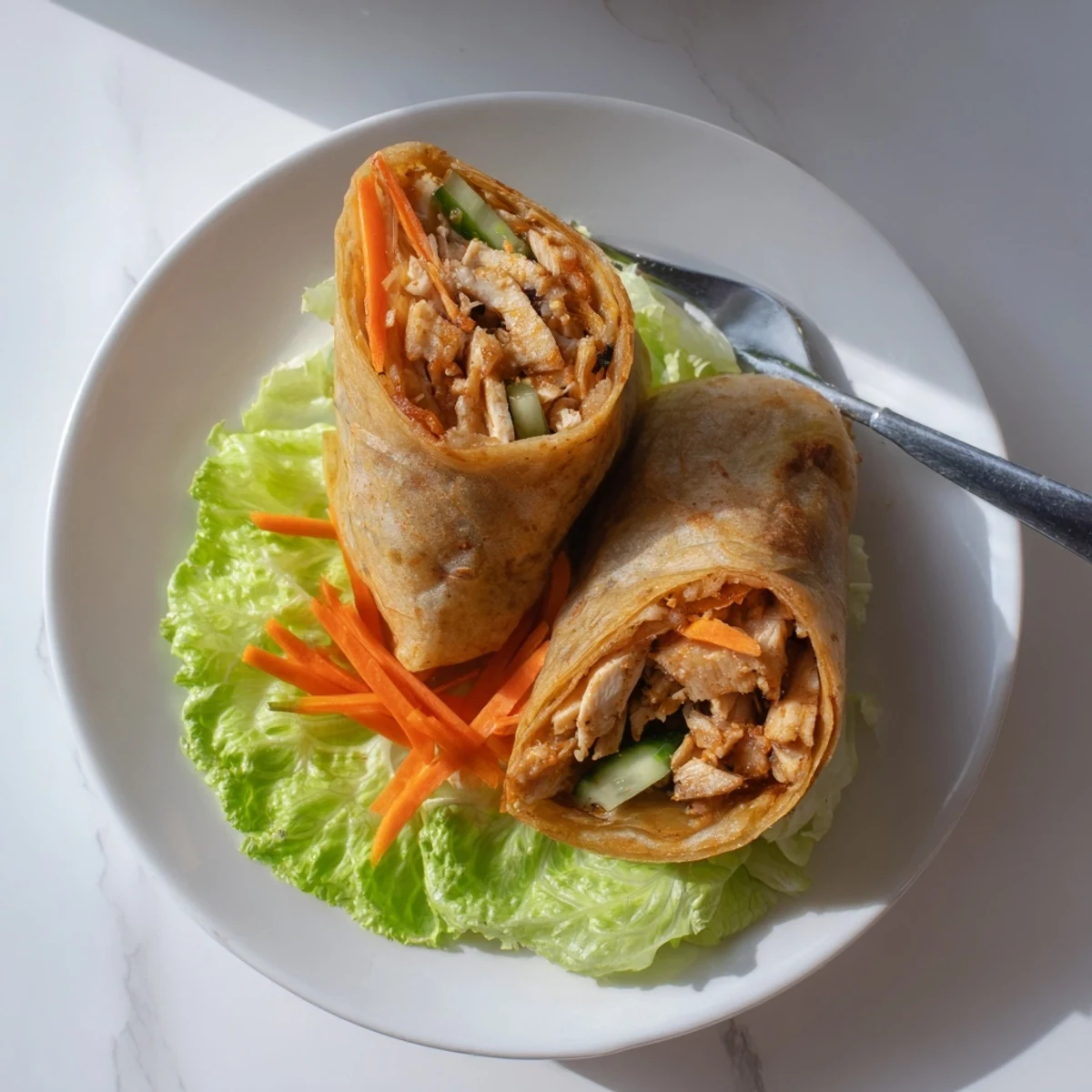 Golden crispy rice paper wraps stuffed with juicy shredded garlicky pulled chicken and fresh veggies.  