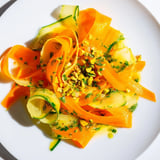 Delicate carrot ribbons in a Citrus Carrot Ribbon Salad, tossed with a zesty citrus dressing and mint.