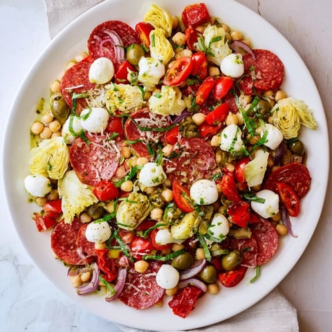 Vibrant Antipasto Chickpea Salad with pepperoni, mozzarella, and a tangy vinaigrette, perfect for a picnic.