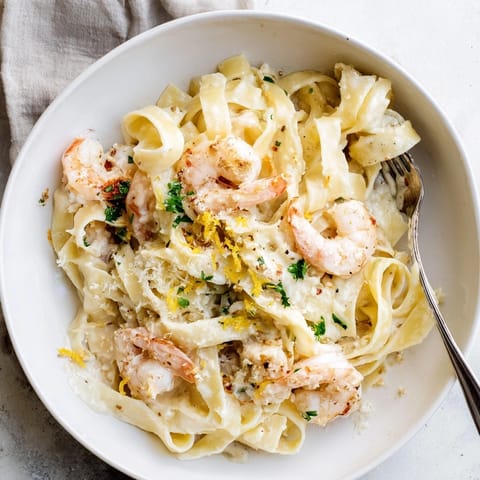Close-up of luscious One-Pot Garlic Butter Shrimp Pasta, garnished beautifully, freshly served.