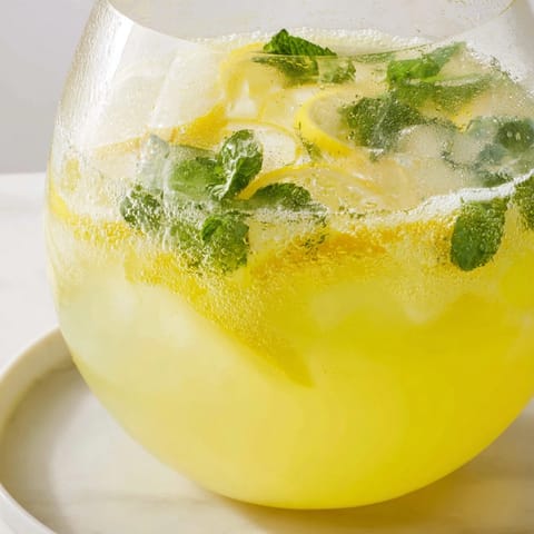 Refreshing homemade Sparkling Lemonade Punch with vodka, perfect for summer parties.