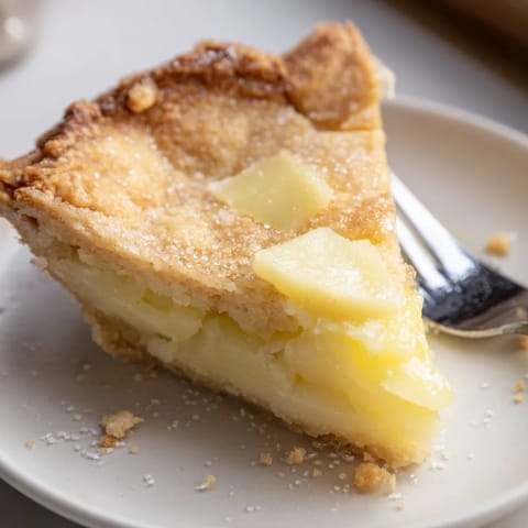 Delicious water pie slice served with fresh berries and a dollop of whipped cream.  