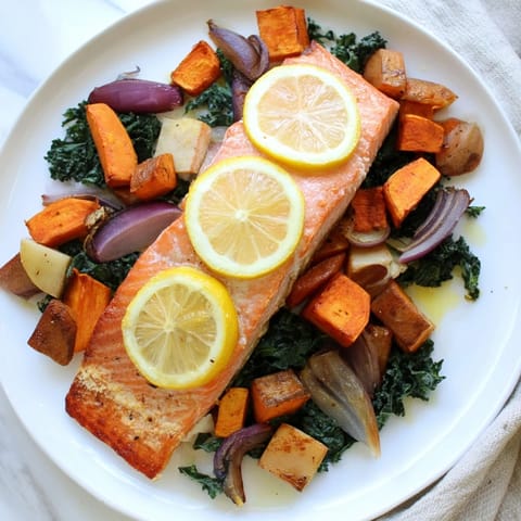 Golden-brown sheet-pan salmon, tender and moist, surrounded by caramelized winter root vegetables.