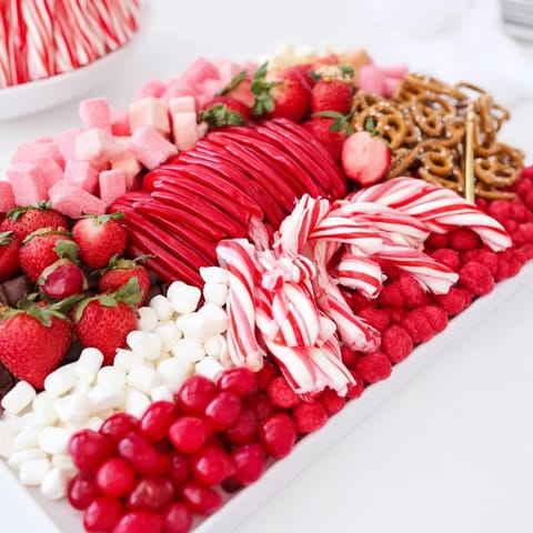 A beautifully arranged Sweet Board creation, filled with vibrant red and white treats, ready to serve.