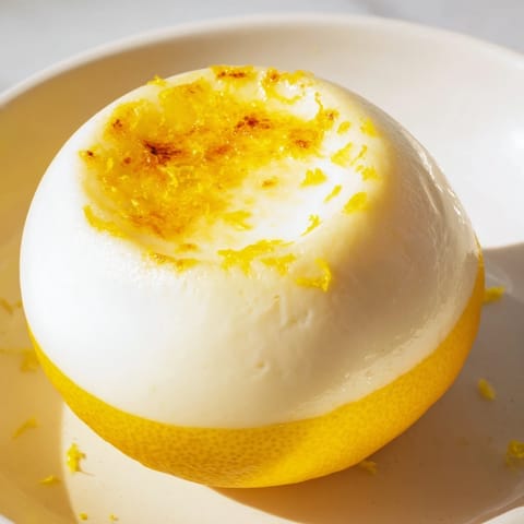 The beautiful texture of Lemon Brûlée Posset, chilled and brimming in lemon shell bowls, a perfect treat.