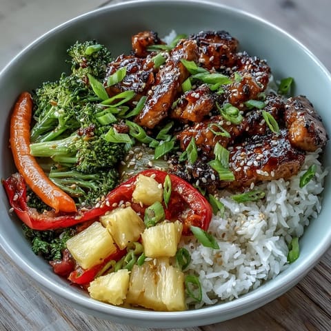 Savory homemade teriyaki chicken served over jasmine rice with crisp broccoli, carrots, bell peppers, and snap peas.
