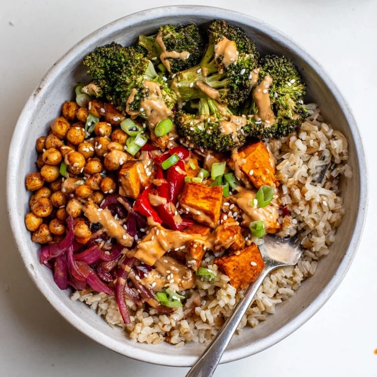 Healthy Bold Sauce Drizzle Bowls with chickpeas and roasted vegetables, drizzled with sauce.