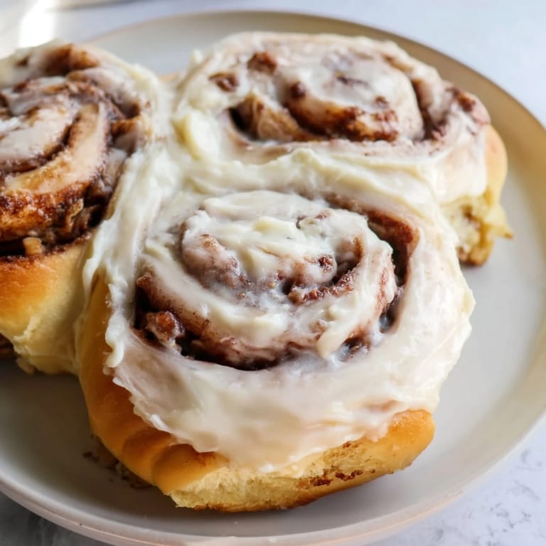 Warm, gooey Viral TikTok Heavy Cream Cinnamon Rolls, saturated with heavy cream and ready to eat!