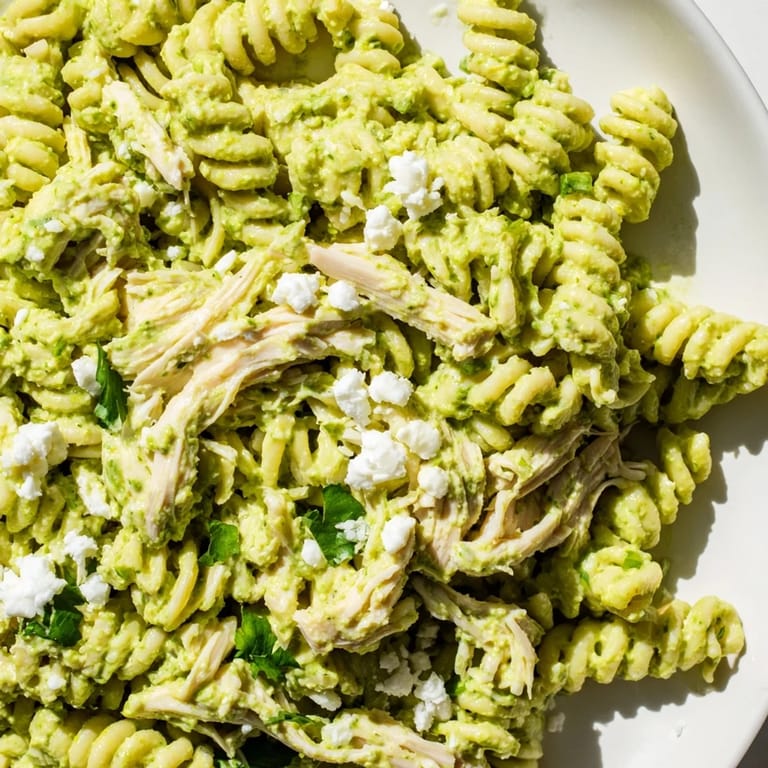 Delicious bowl of Cilantro Lime Chicken Pasta with tender rotini and juicy shredded chicken tossed in a fresh, zesty yogurt sauce.