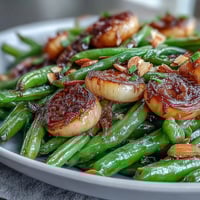 Roasted Garlic Green Beans with golden caramelized garlic and bright lemon zest, perfect for a savory Easter side dish.